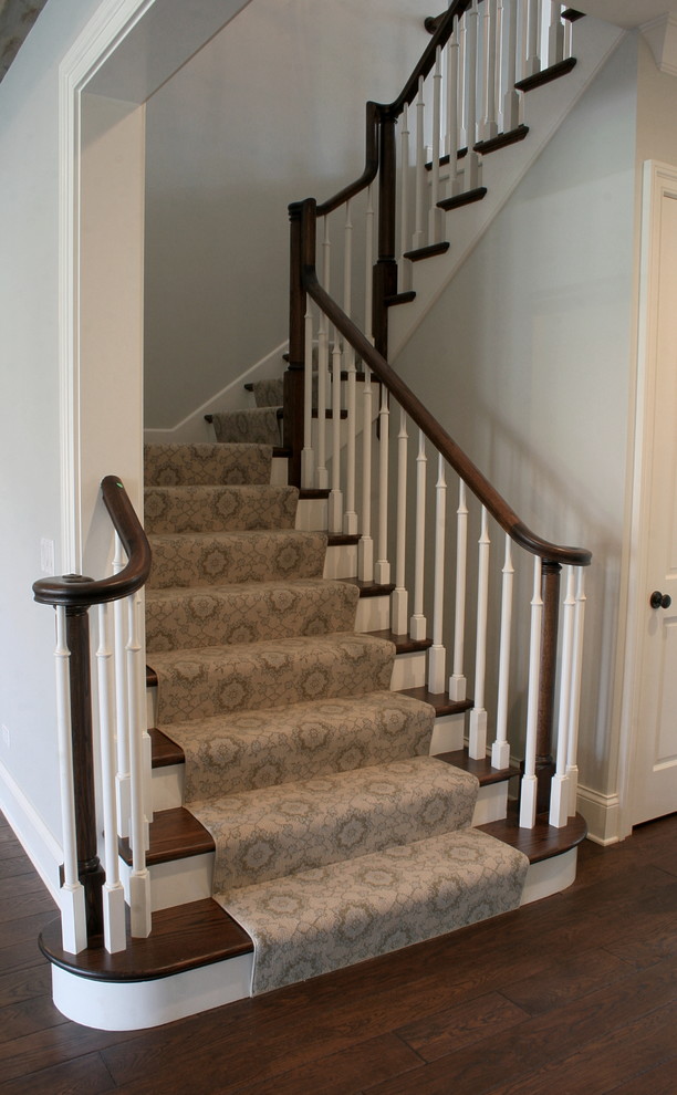 This is an example of a traditional wood u-shaped staircase in Chicago with painted wood risers.