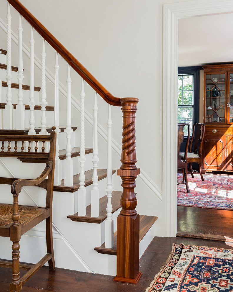Traditional wood straight staircase in Boston with painted wood risers.