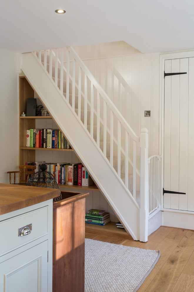 Design ideas for a medium sized farmhouse staircase in Other with under stair storage.