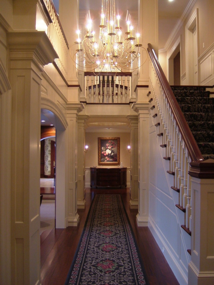 Inspiration for a mid-sized timeless wooden straight staircase remodel in Boston with painted risers