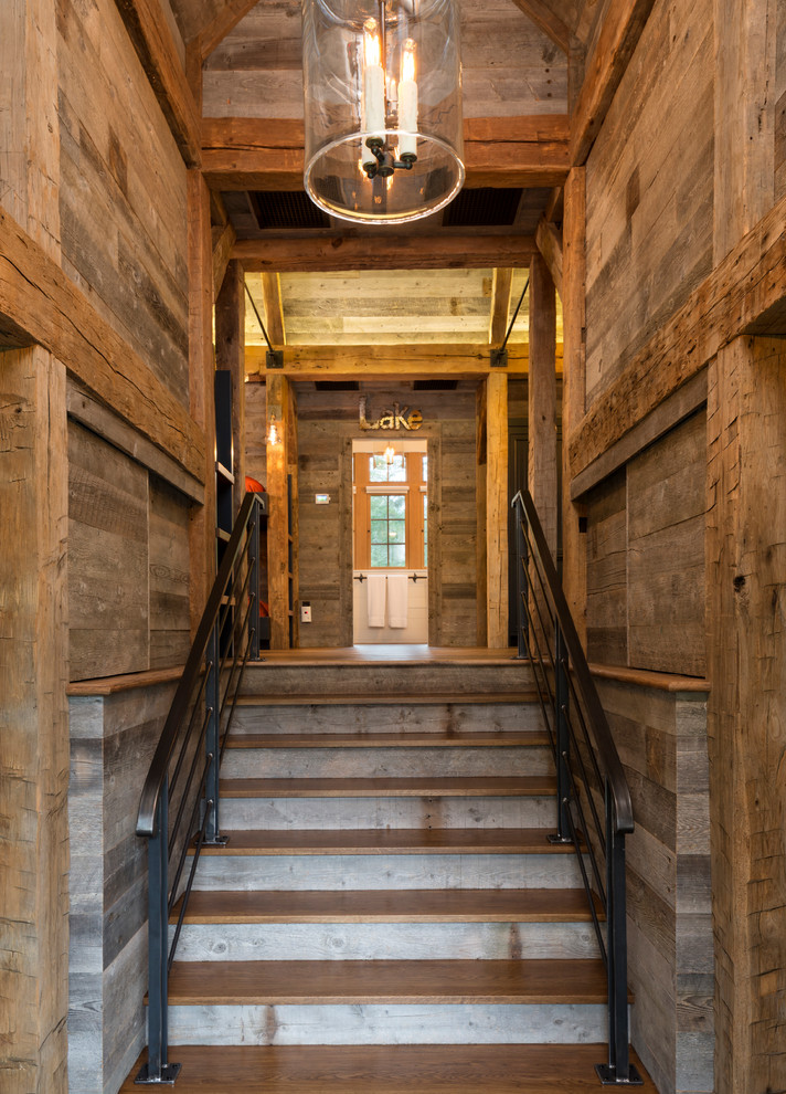 Staircase - rustic wooden straight staircase idea in Minneapolis with wooden risers