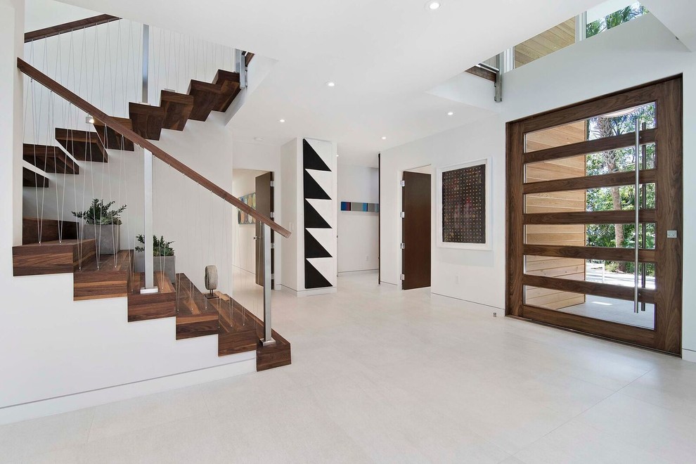 Contemporary wood wire cable railing staircase in Orlando with wood risers.