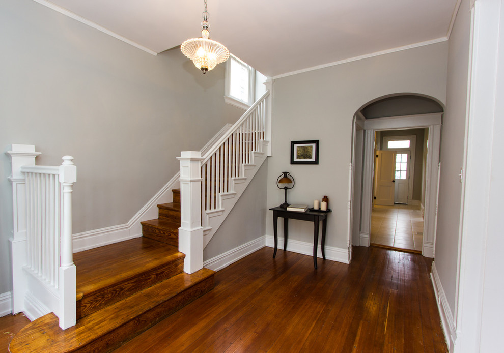 Photo of a large traditional wood l-shaped staircase in Richmond.