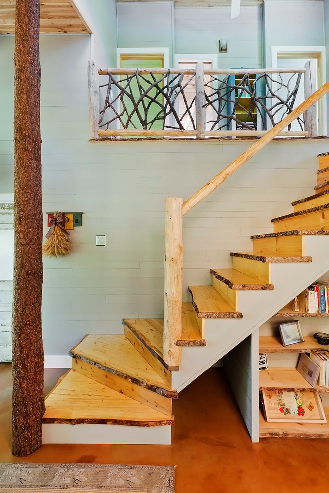 Inspiration for a rural wood curved wood railing staircase in Minneapolis with wood risers.