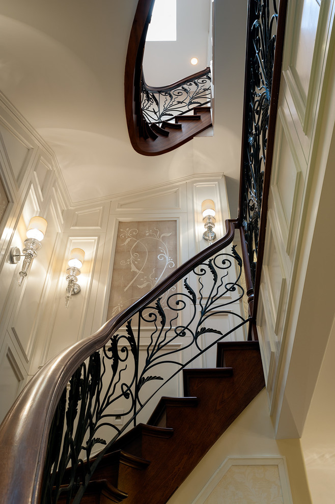 Example of a large transitional wooden curved staircase design in New York with wooden risers