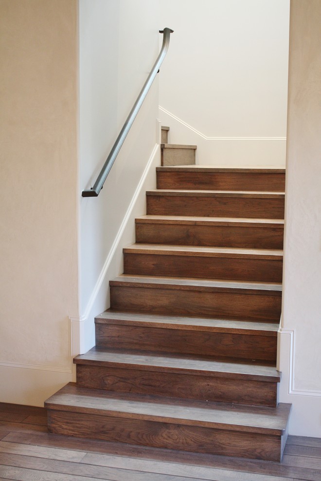 Ejemplo de escalera en L rústica con escalones de madera y contrahuellas de madera