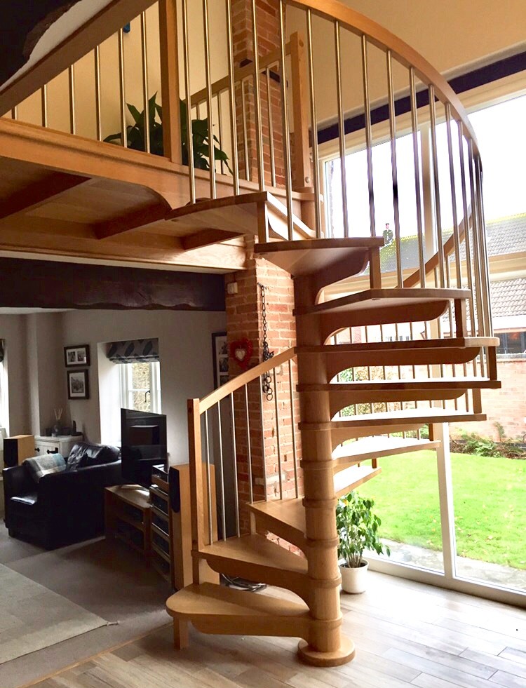 Example of a mid-sized trendy wooden spiral mixed material railing staircase design in Other with wooden risers