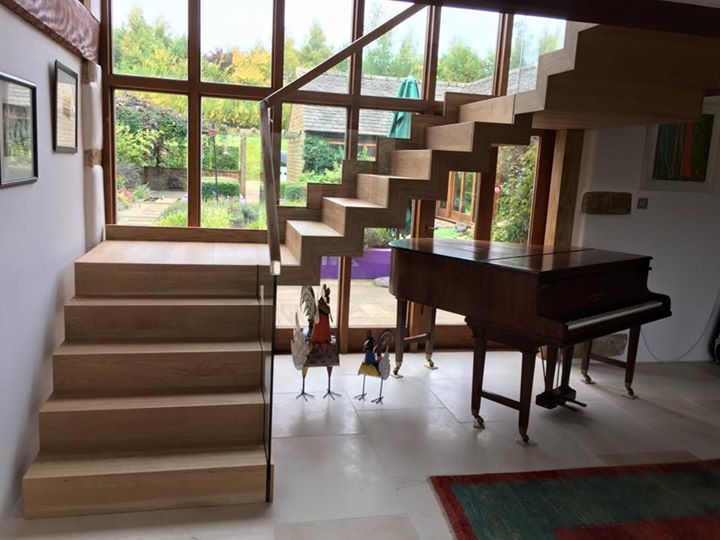 Inspiration for a medium sized contemporary wood floating staircase in Wiltshire with wood risers.