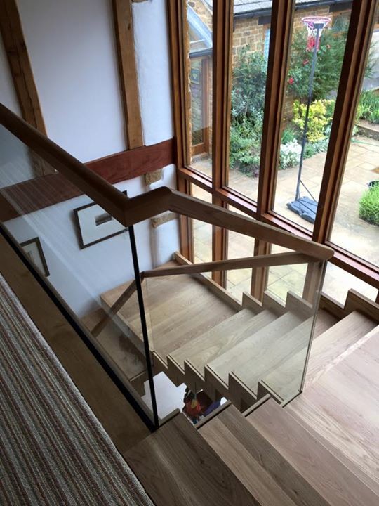 Medium sized contemporary wood floating staircase in Wiltshire with wood risers.