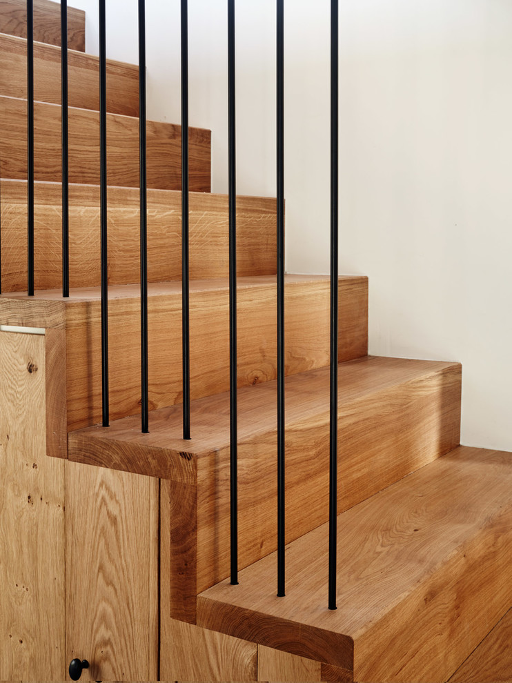 Esempio di una scala a rampa dritta design di medie dimensioni con pedata in legno, alzata in legno e parapetto in metallo