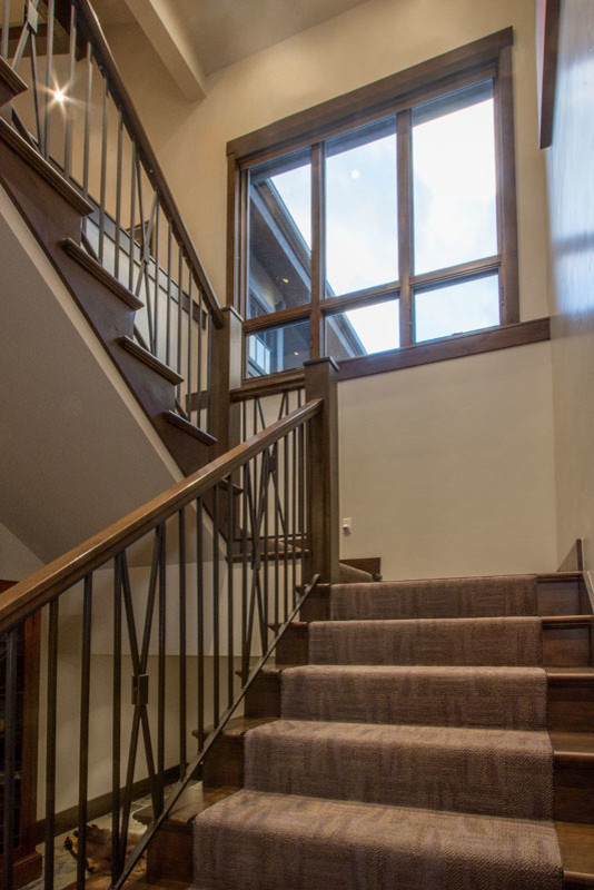 This is an example of a medium sized classic carpeted u-shaped staircase in Salt Lake City with carpeted risers.