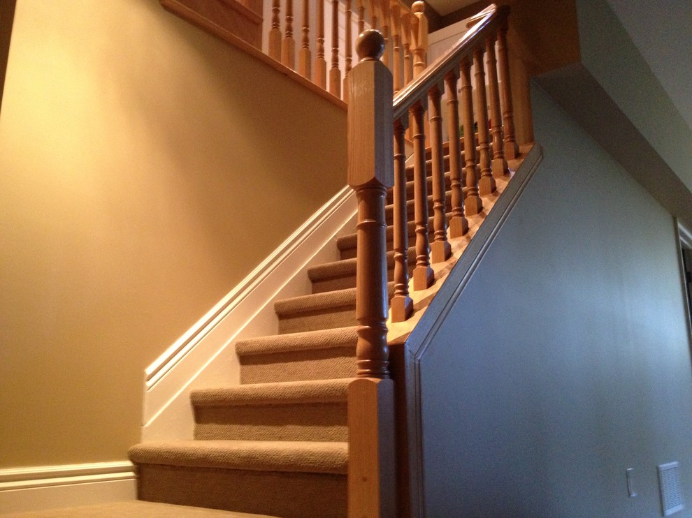 Mid-sized elegant carpeted straight staircase photo in Toronto with carpeted risers