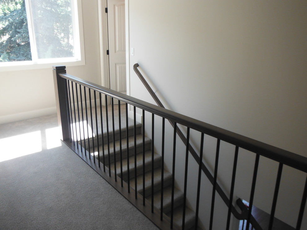 Mid-sized trendy carpeted straight wood railing staircase photo in Vancouver with carpeted risers
