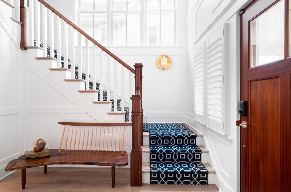 Imagen de escalera en U marinera con escalones de madera, contrahuellas de madera y barandilla de madera
