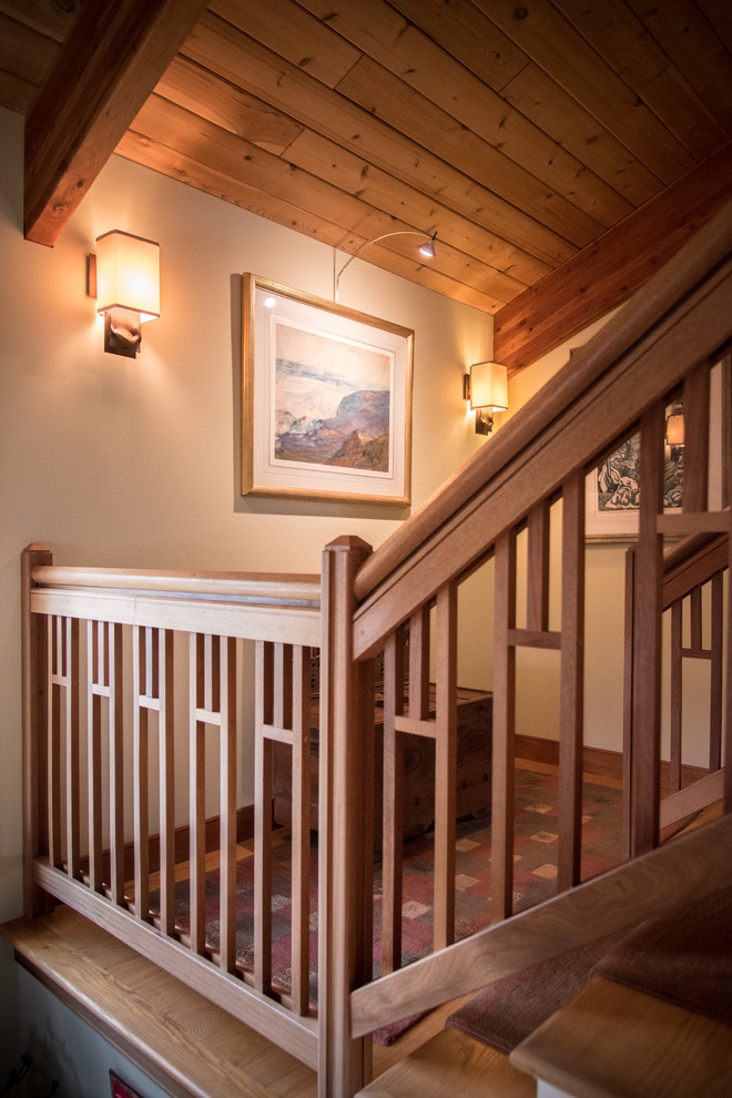 Mid-sized mountain style carpeted straight wood railing staircase photo in Portland Maine with carpeted risers