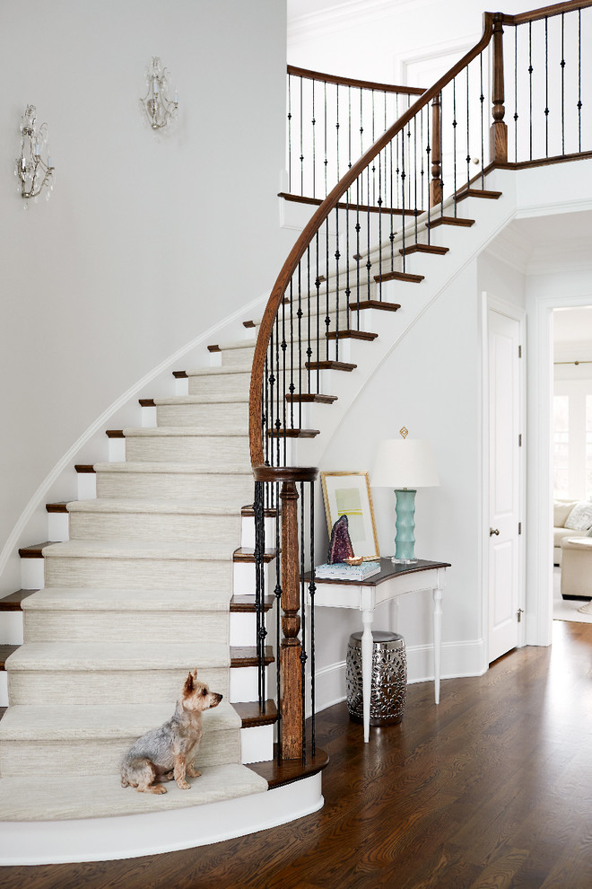 Design ideas for a classic wood curved staircase in Raleigh with painted wood risers and feature lighting.
