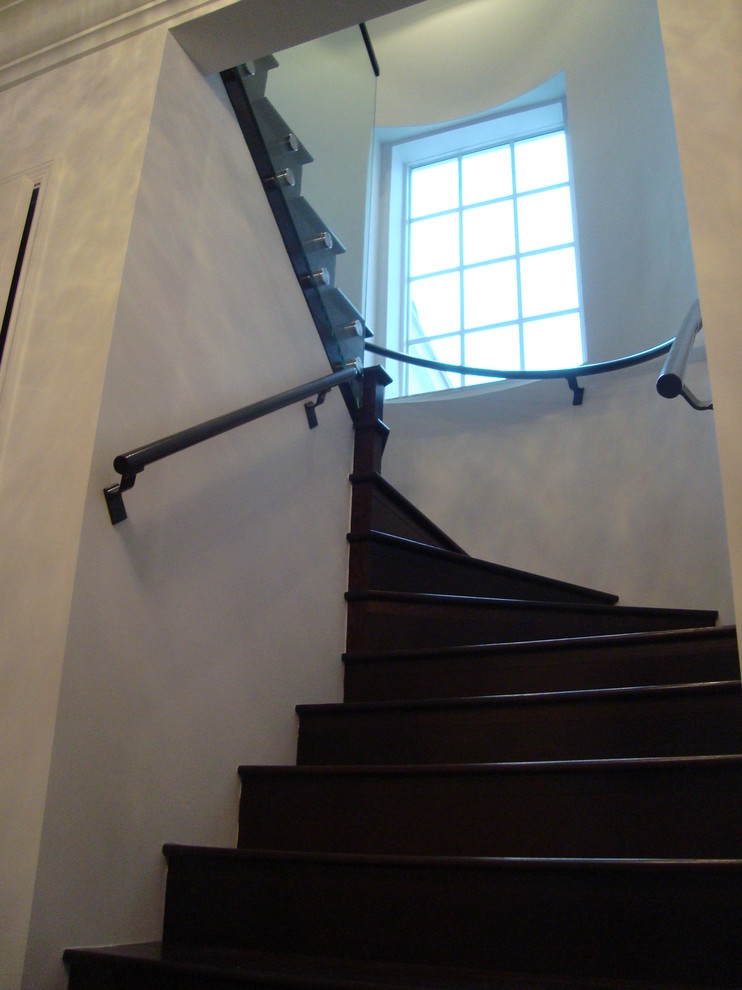Small trendy wooden curved glass railing staircase photo in Tampa with wooden risers