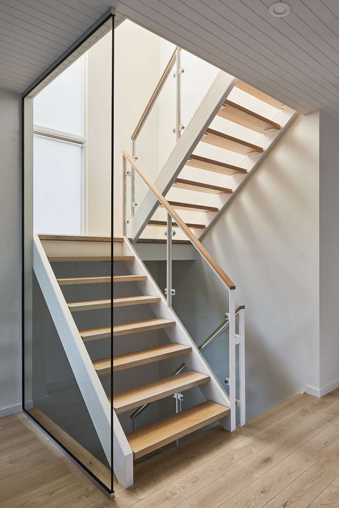 Staircase - mid-sized contemporary wooden u-shaped open and metal railing staircase idea in Toronto