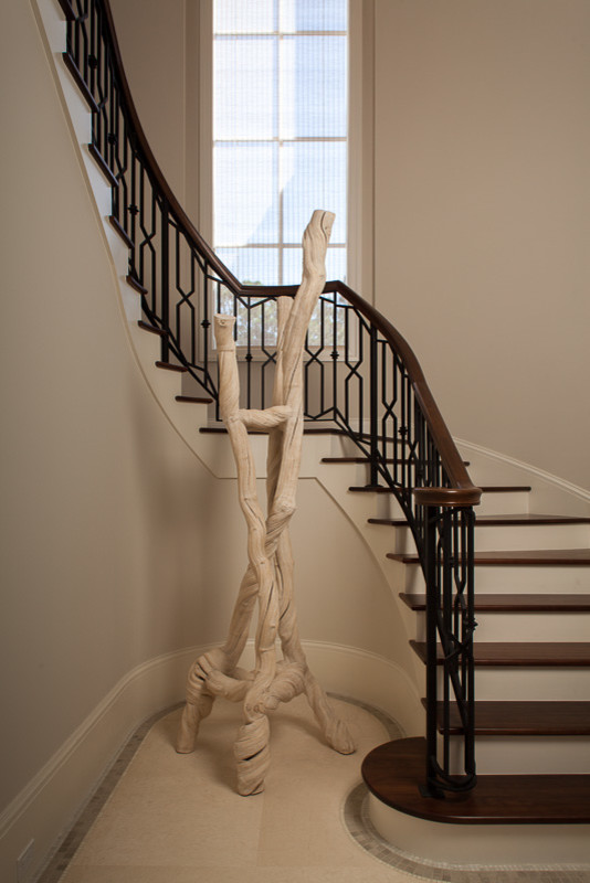 Example of a huge transitional wooden curved staircase design in Miami with wooden risers