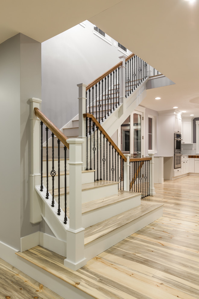 Traditional wood l-shaped staircase in Denver with painted wood risers.