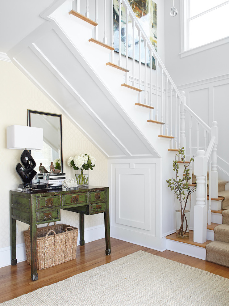Large traditional u-shaped staircase in San Francisco with feature lighting.