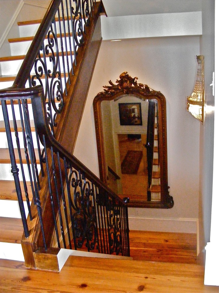 Design ideas for a large traditional wood l-shaped staircase in Charleston with painted wood risers.
