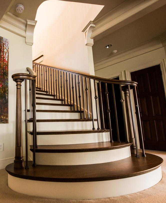 Staircase - large traditional wooden curved staircase idea in Seattle with painted risers