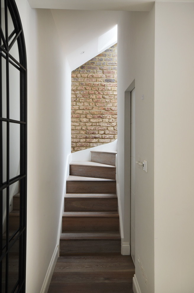 Design ideas for a small contemporary wood l-shaped staircase in London with wood risers.
