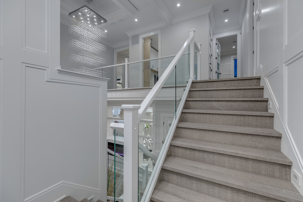 Example of a mid-sized trendy wooden l-shaped glass railing staircase design in Vancouver with wooden risers