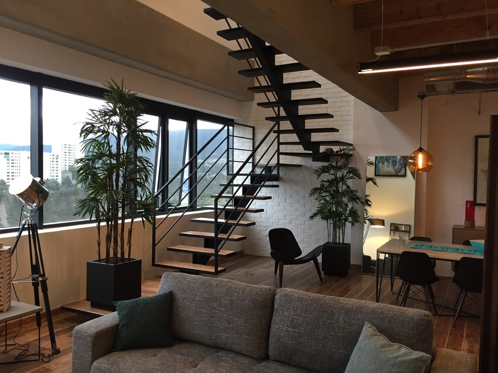 Design ideas for a small industrial wood floating metal railing staircase in Mexico City with metal risers and feature lighting.