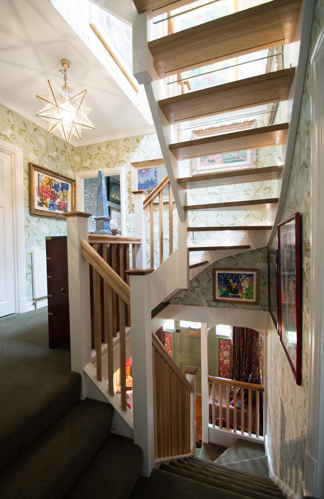 This is an example of a small contemporary wood floating wood railing staircase with open risers.