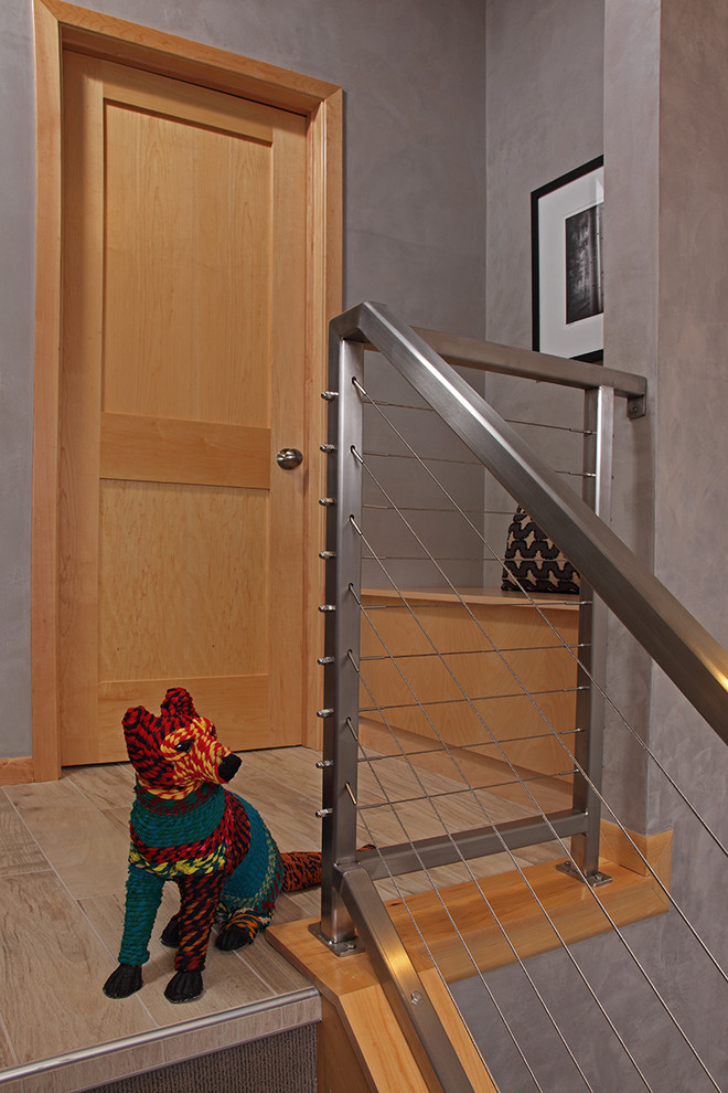 Design ideas for a small modern tiled staircase in Minneapolis with tiled risers.