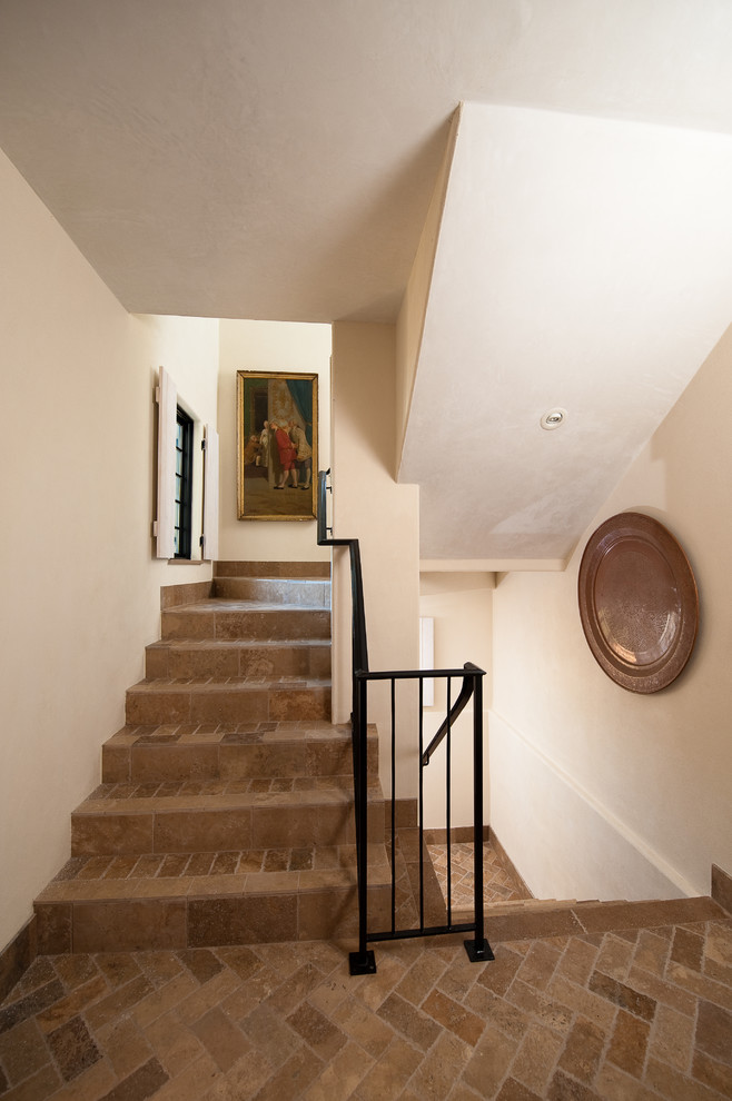 Пример оригинального дизайна: п-образная лестница среднего размера в средиземноморском стиле с ступенями из плитки, подступенками из плитки и металлическими перилами
