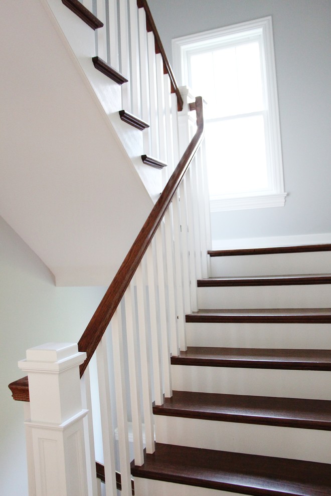 Example of a mid-sized transitional wooden u-shaped staircase design in Chicago with wooden risers