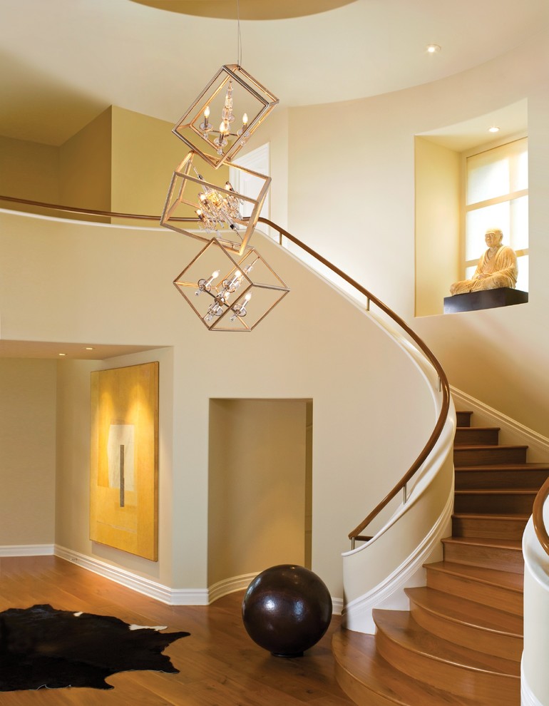 Photo of a large contemporary wood curved wood railing staircase in Salt Lake City with wood risers.