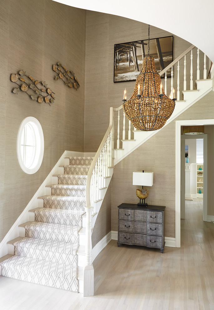This is an example of a medium sized nautical wood l-shaped wood railing staircase in New York with painted wood risers and feature lighting.