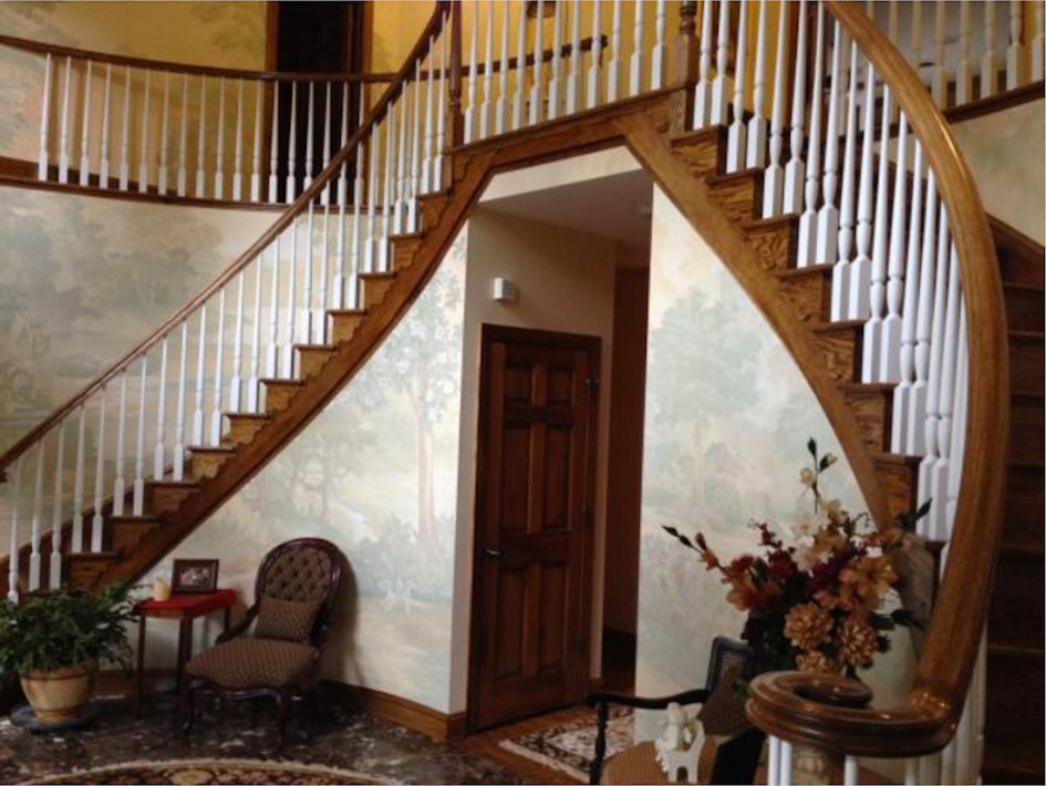 Large elegant wooden curved staircase photo in Baltimore with wooden risers