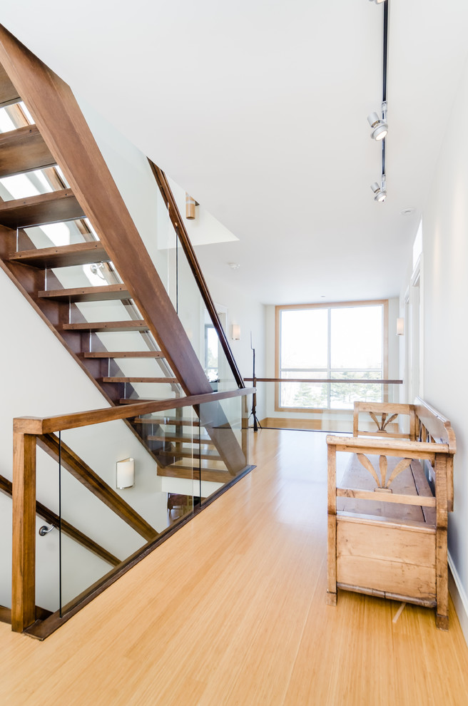 Источник вдохновения для домашнего уюта: большая прямая лестница в современном стиле с деревянными ступенями, стеклянными подступенками и стеклянными перилами
