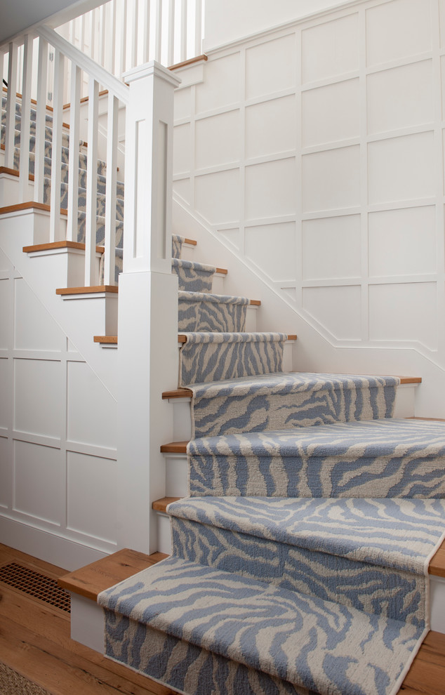 Mid-sized transitional wooden curved wood railing staircase photo in Boston with painted risers