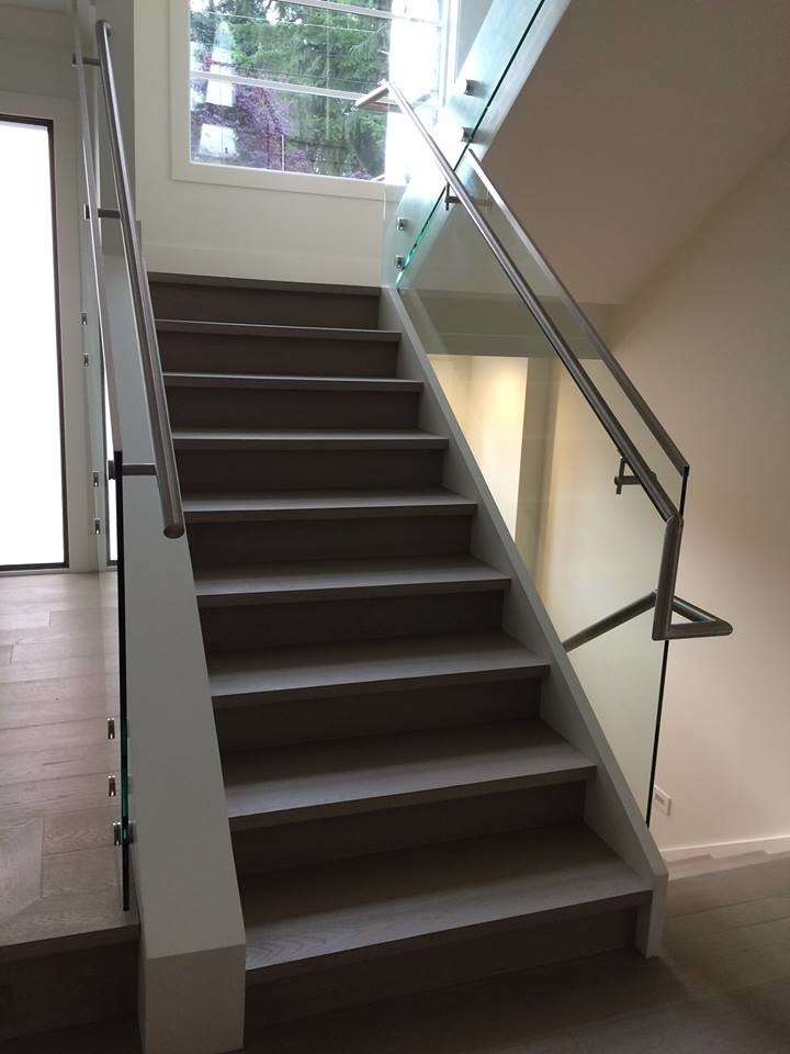 Mid-sized minimalist wooden straight metal railing staircase photo in Vancouver with wooden risers