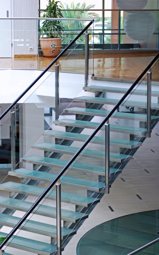 Foto de escalera recta minimalista grande sin contrahuella con escalones de vidrio