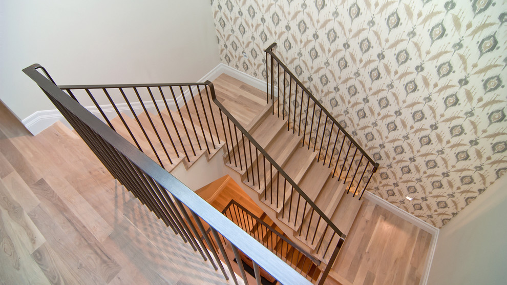 Photo of a classic wood u-shaped metal railing staircase in San Francisco with wood risers.