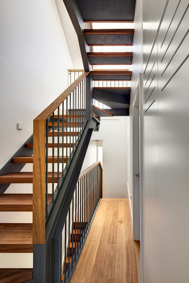 Small modern wood u-shaped staircase in Sydney with open risers.