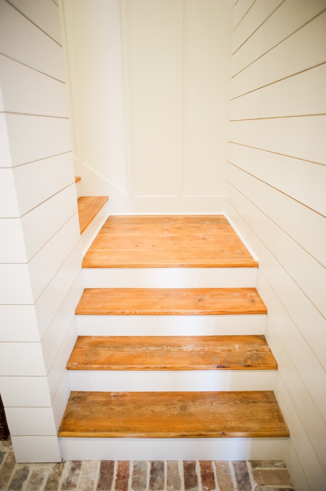 Inspiration for a mid-sized cottage wooden l-shaped wood railing staircase remodel in Houston with wooden risers
