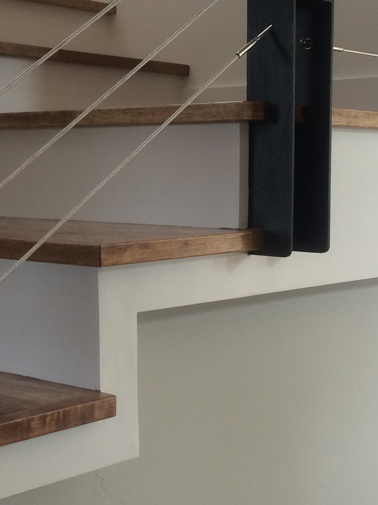 Inspiration for a mid-sized transitional wooden u-shaped staircase remodel in San Francisco with painted risers
