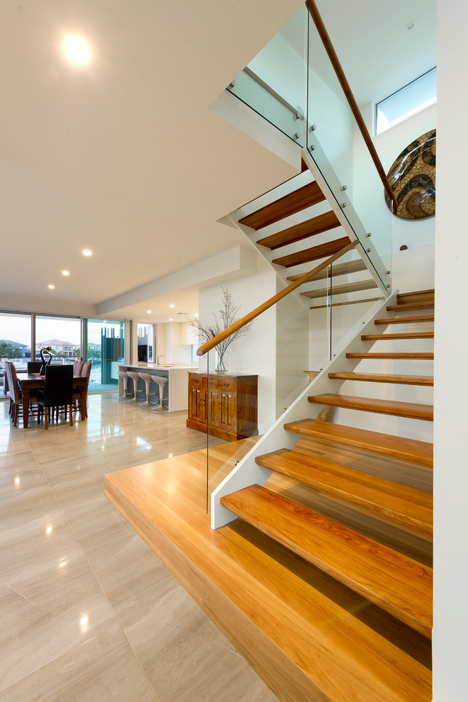 This is an example of a contemporary wood u-shaped staircase in Sunshine Coast with open risers.