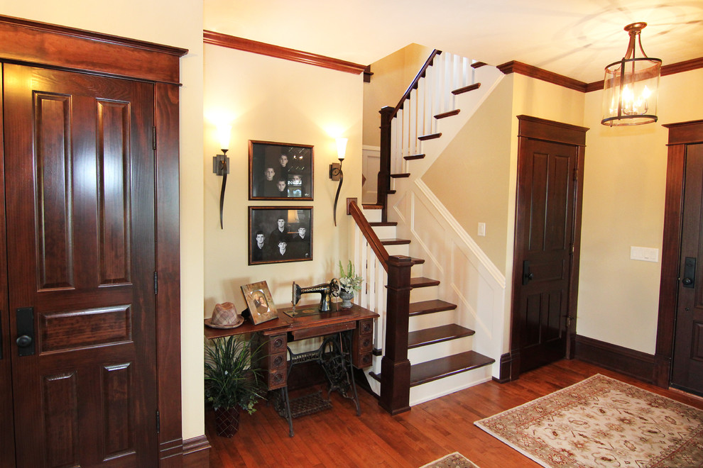 This is an example of a medium sized rural wood u-shaped staircase in Other with painted wood risers.