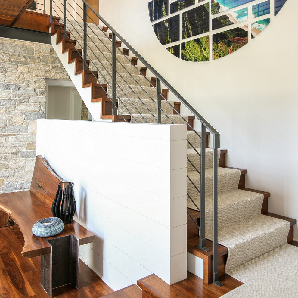 This is an example of a large rustic wood straight metal railing staircase in New York.
