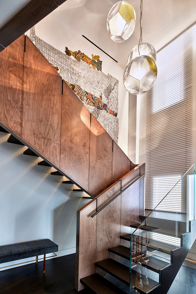 Contemporary wood u-shaped staircase in New York with open risers and feature lighting.