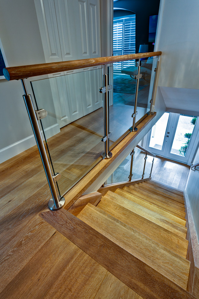 This is an example of a medium sized nautical wood straight staircase in Miami with open risers.